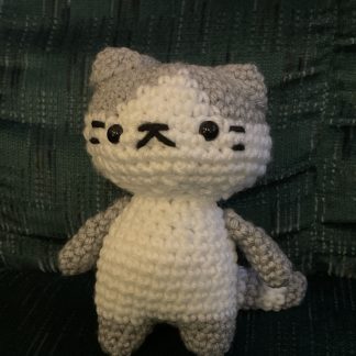 A crocheted grey and white cat.