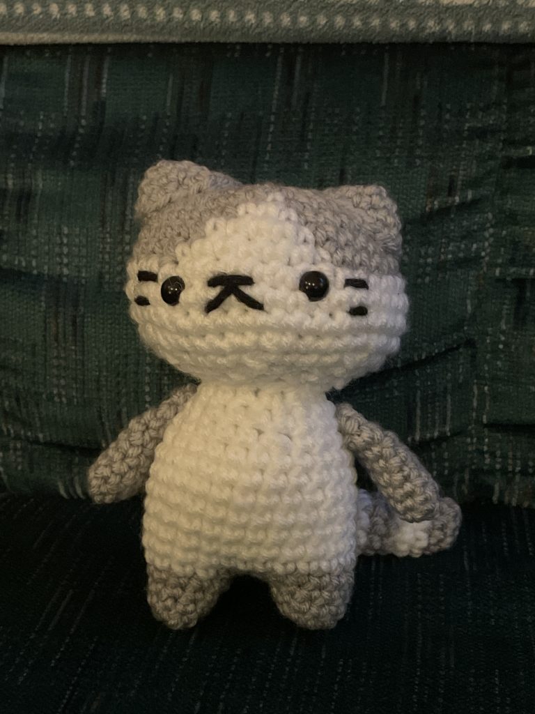 A crocheted grey and white cat.